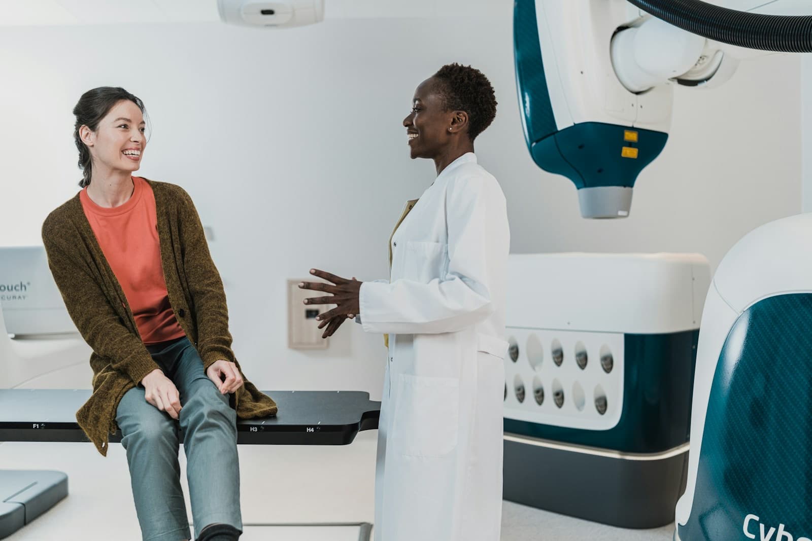 A clinician and patient talking in a bright modern treatment room